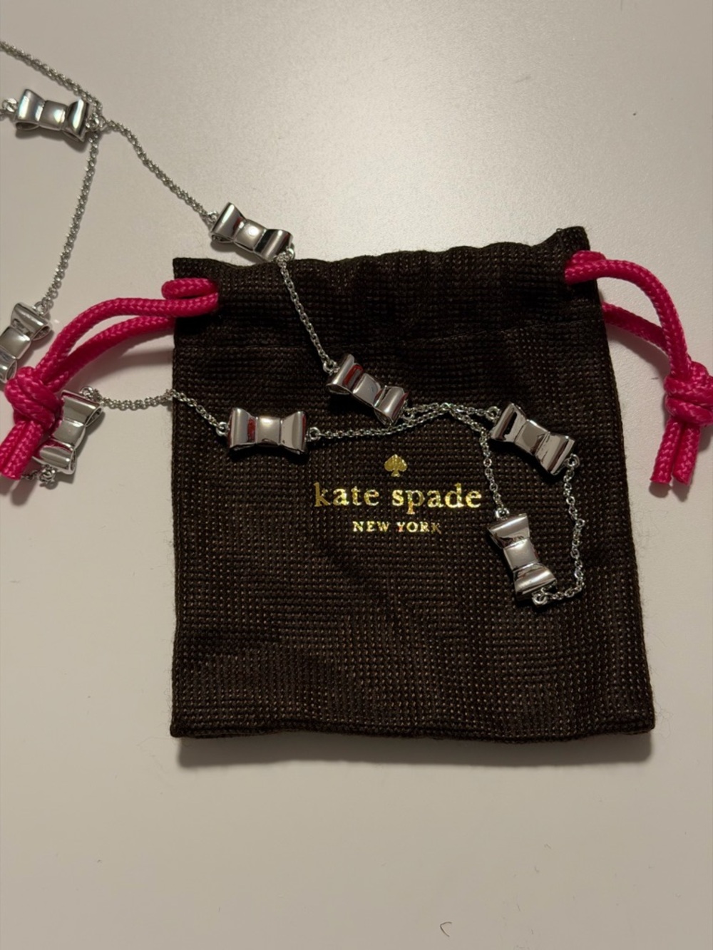 kate spade Silver Bow Link Necklace with Pink Drawstring Pouch
